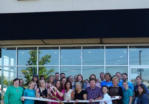 Cari Cousins, owners, cuts the ribbon celebrating BIGGBY Coffee's Opening