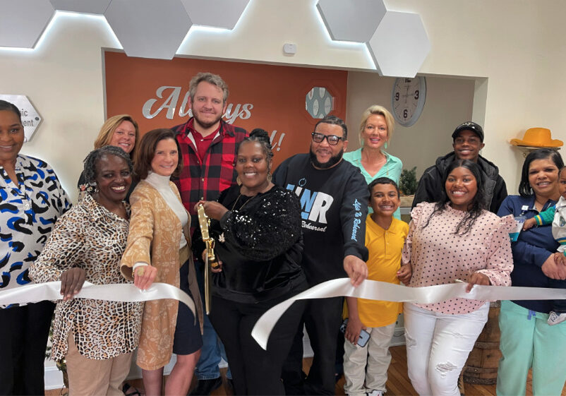 Chlandra Chenault cuts the ribbon celebrating Designs &amp; More membership into the Winchester-Clark County Chamber of Commerce.