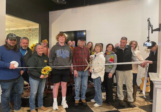 rish Torline cuts the ribbon celebrating Heartstrings Songwriters Circle membership into the Winchester-Clark County Chamber of Commerce.