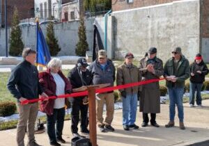 Veterans Council members David Ward, Dianna Layne, Greg Yates, Don Rose, Chuck Witt, and Dee Birkes watching as Council President Roy Hudson did the honors of cutting the red ribbon to officially open the memorial.